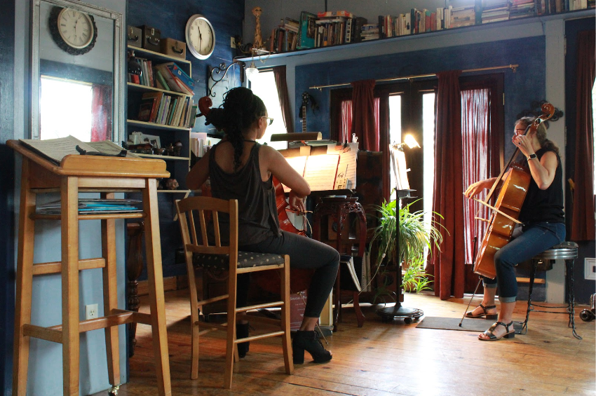 Harriett playing cello with student during music lessons in Colorado Springs