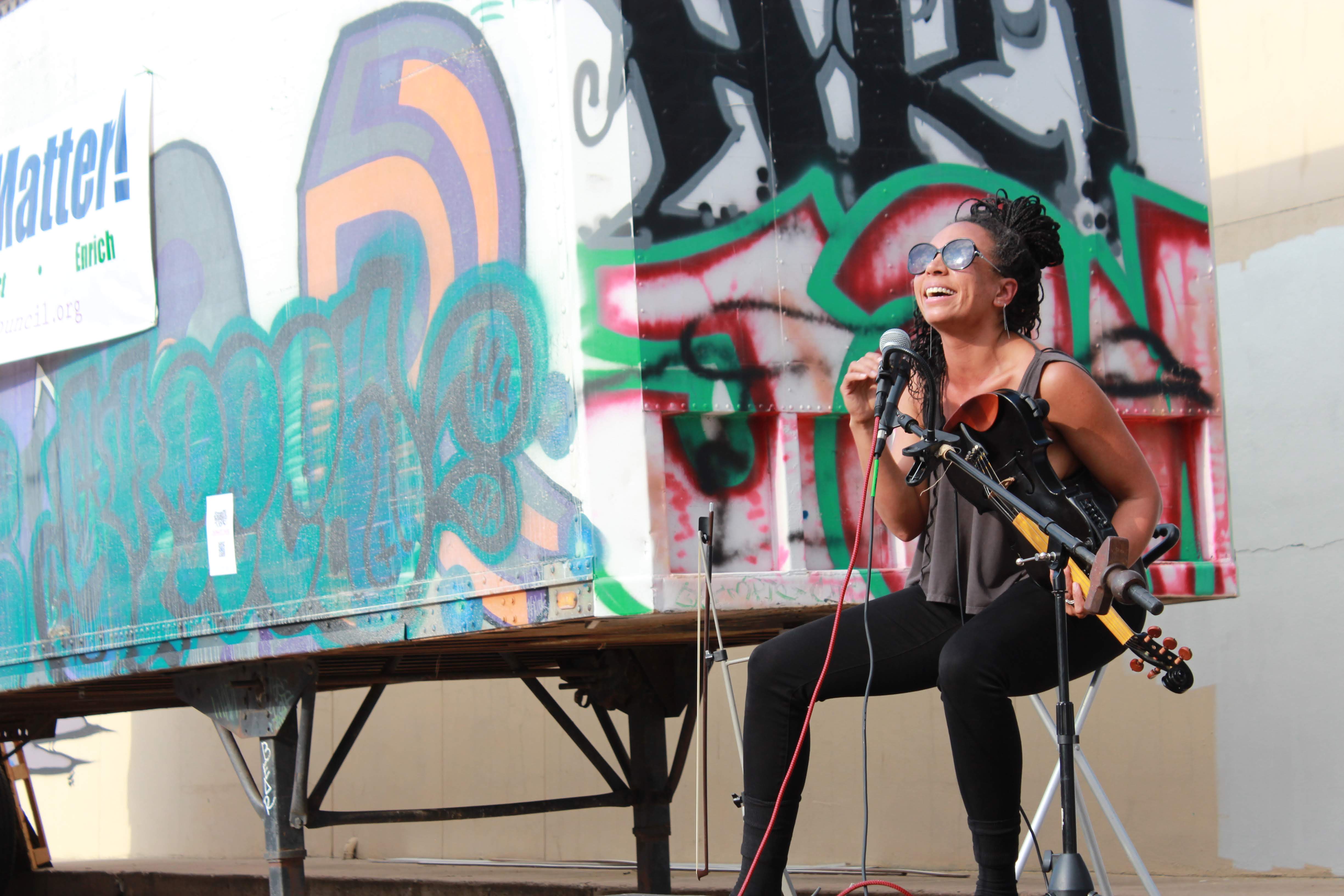 Harriett playing electric violin during a performance in Colorado Springs