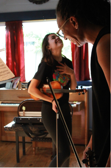 Harriett laughing and talking to student during music lessons in Colorado Springs