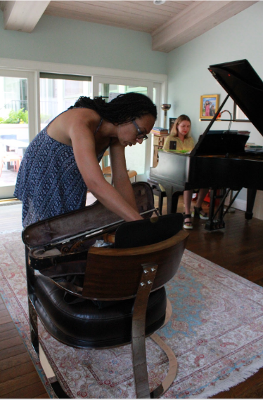 Harriett preparing violin for duet with student during music lessons in Colorado Springs