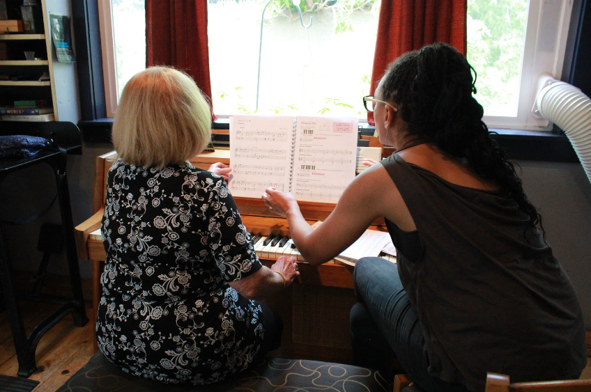 Harriett teaching piano during music lessons in Colorado Springs